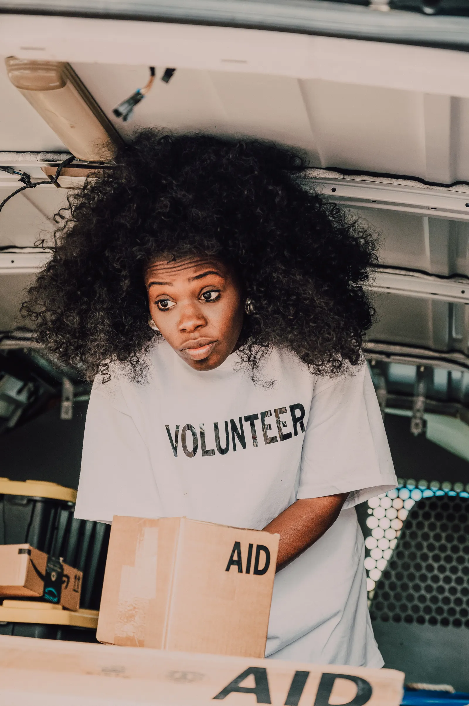 A volunteer sorting boxes of humanitarian supplies